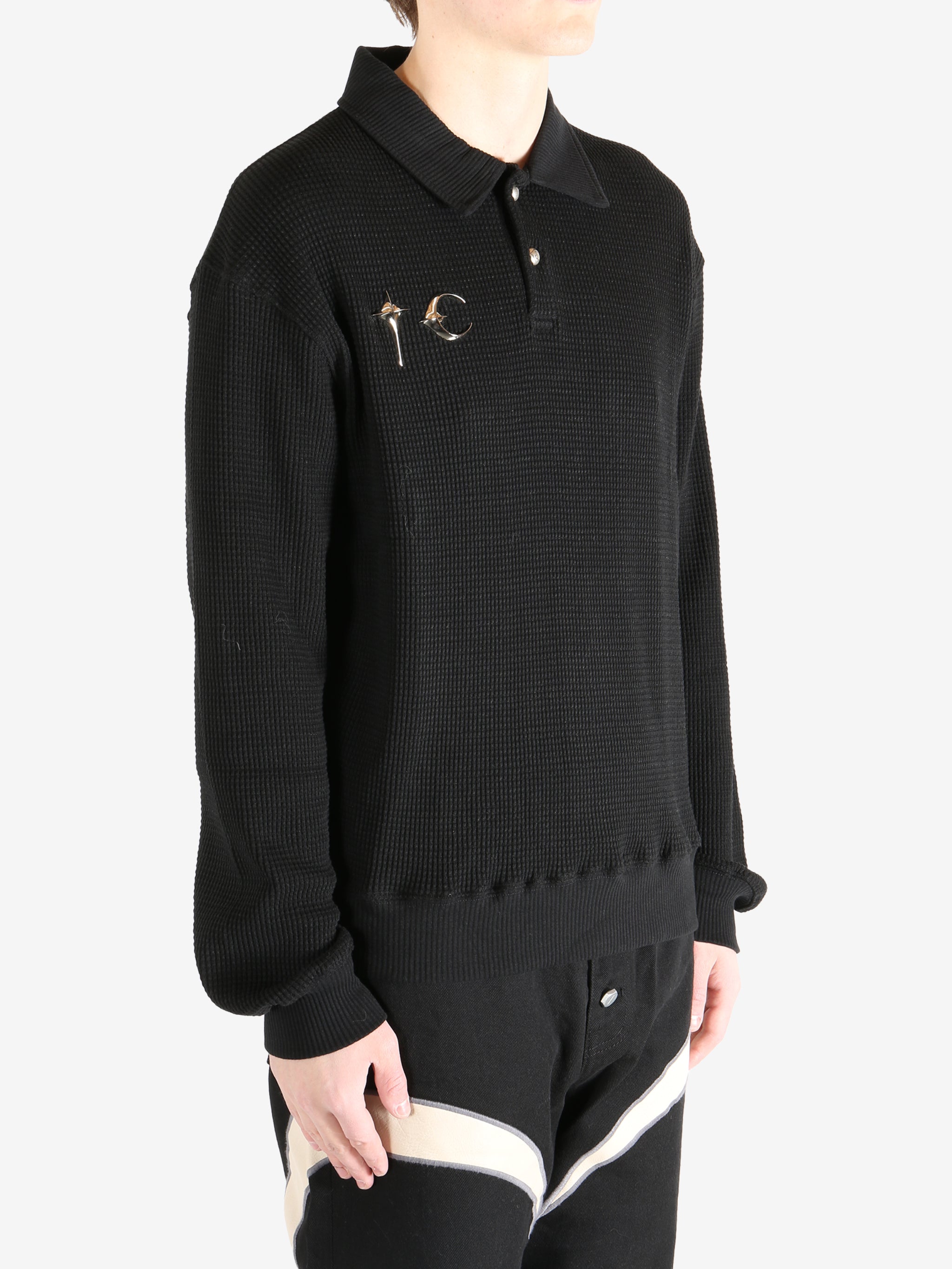 Black T-shirt worn by a person, showing the shirt's fit