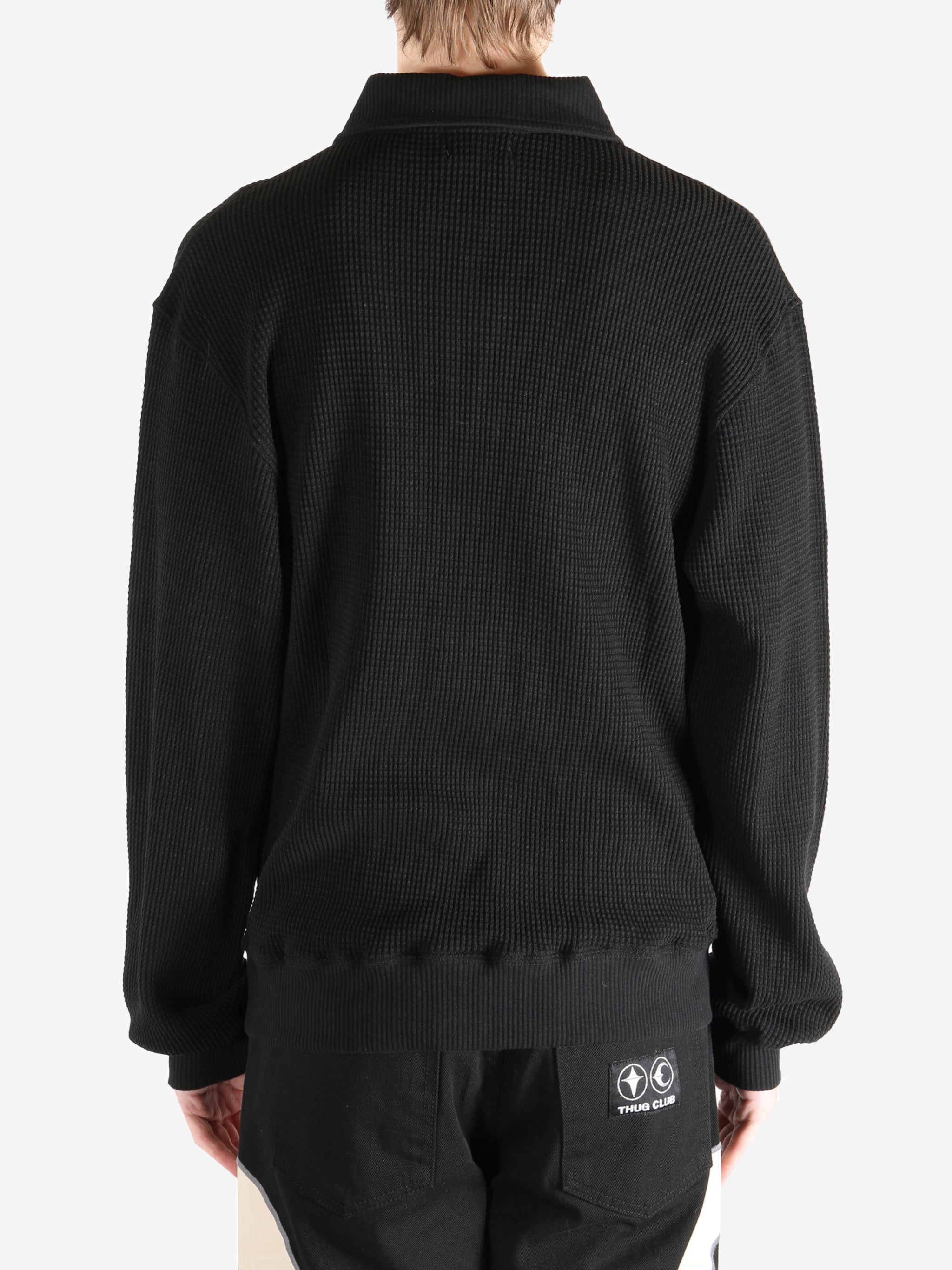 Black T-shirt worn by a person, showing the shirt's fit