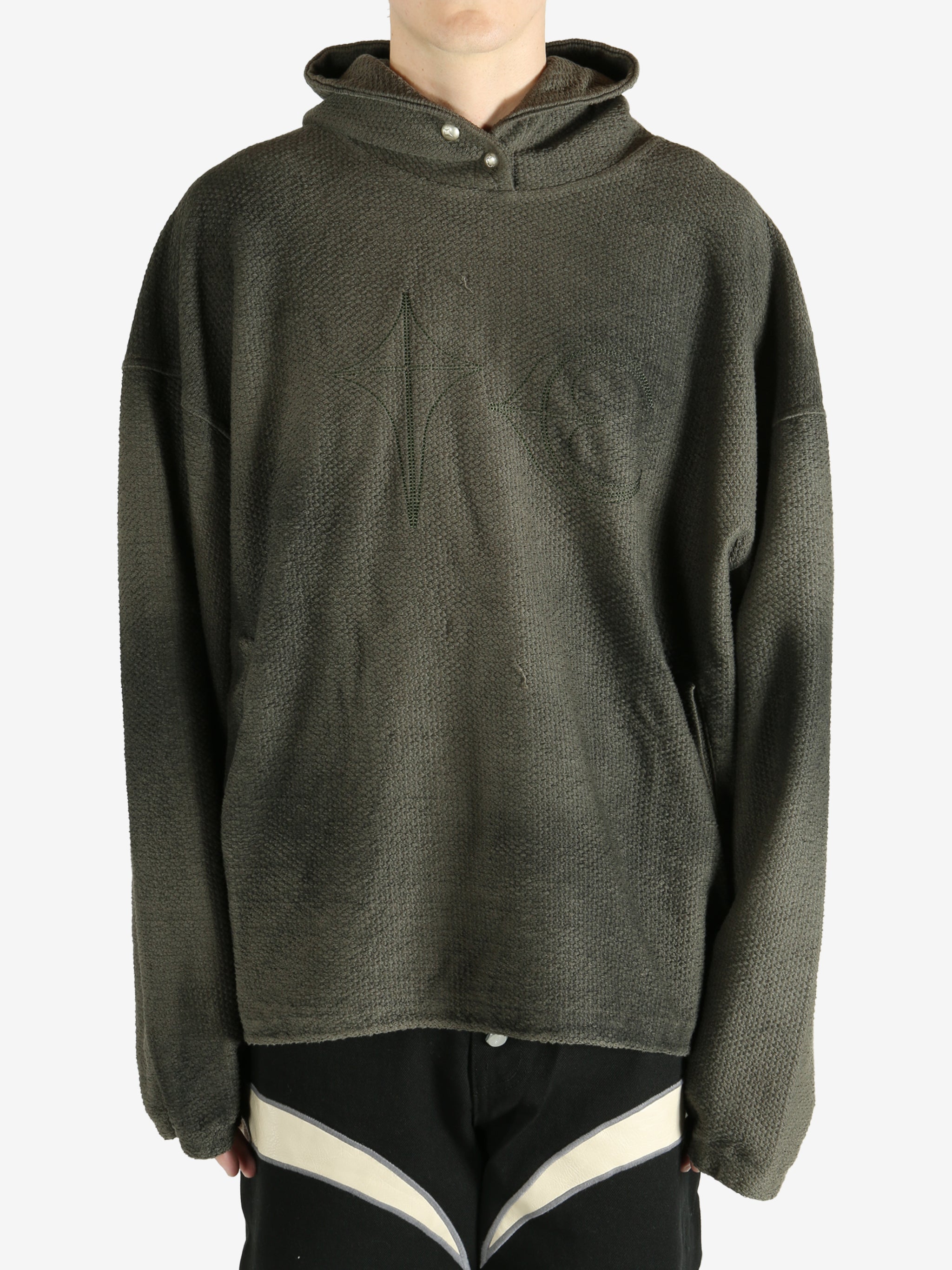 Green hoodie worn by a person, showing the hoodie's fit