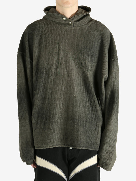 Green hoodie worn by a person, showing the hoodie's fit