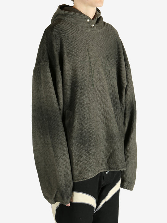 Green hoodie worn by a person, showing the hoodie's fit