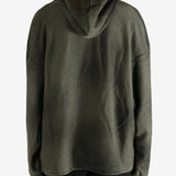 Green hoodie worn by a person, showing the hoodie's fit