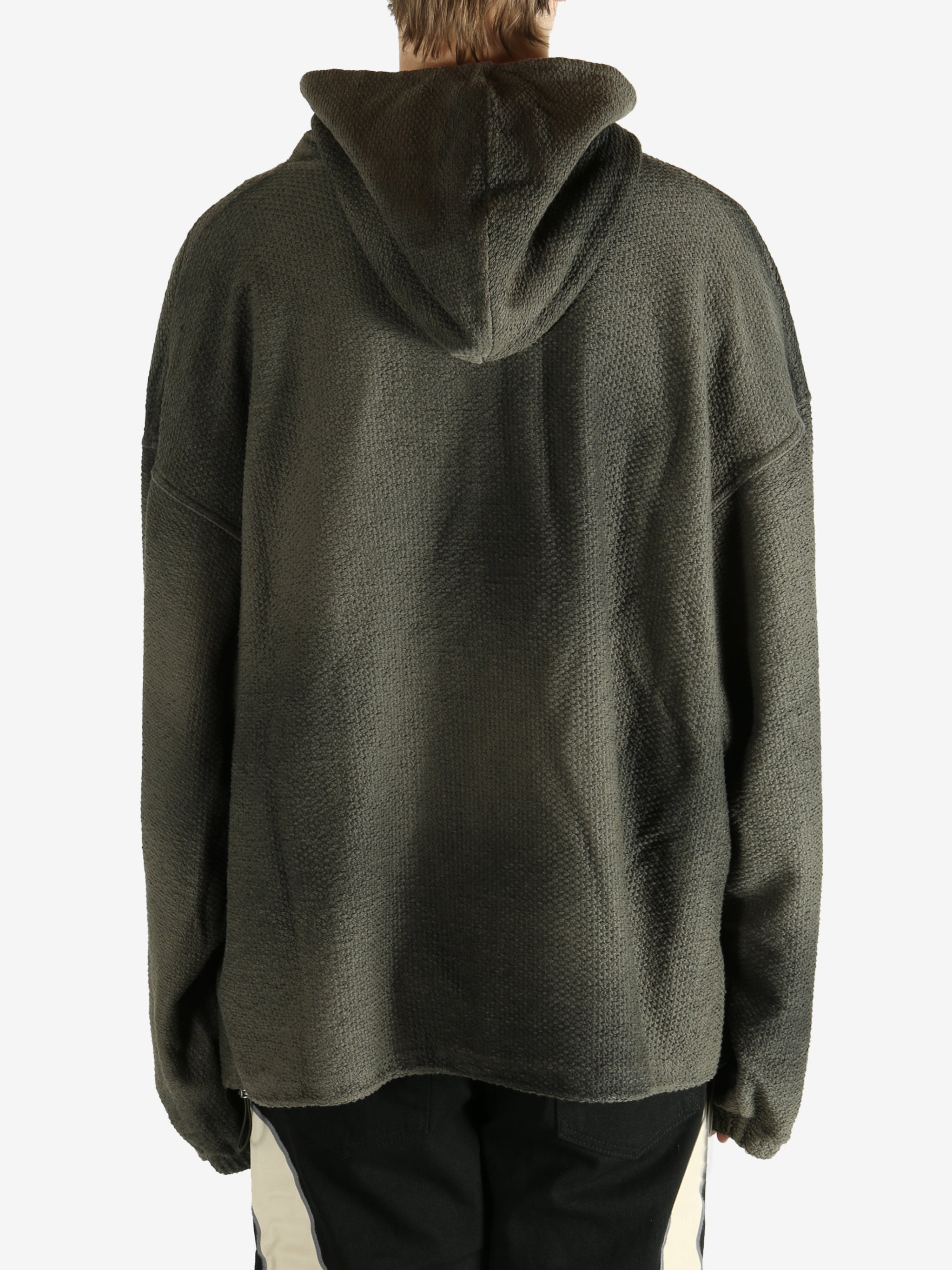 Green hoodie worn by a person, showing the hoodie's fit