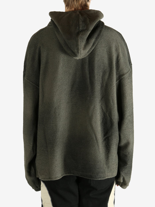 Green hoodie worn by a person, showing the hoodie's fit