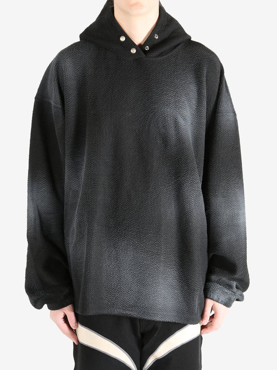 Black hoodie worn by a person, showing the hoodie's fit