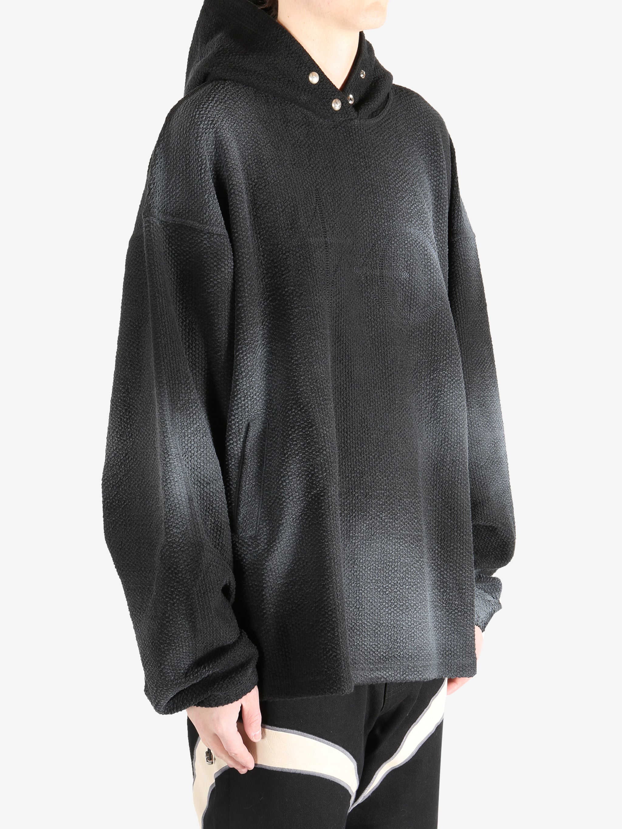 Black hoodie worn by a person, showing the hoodie's fit