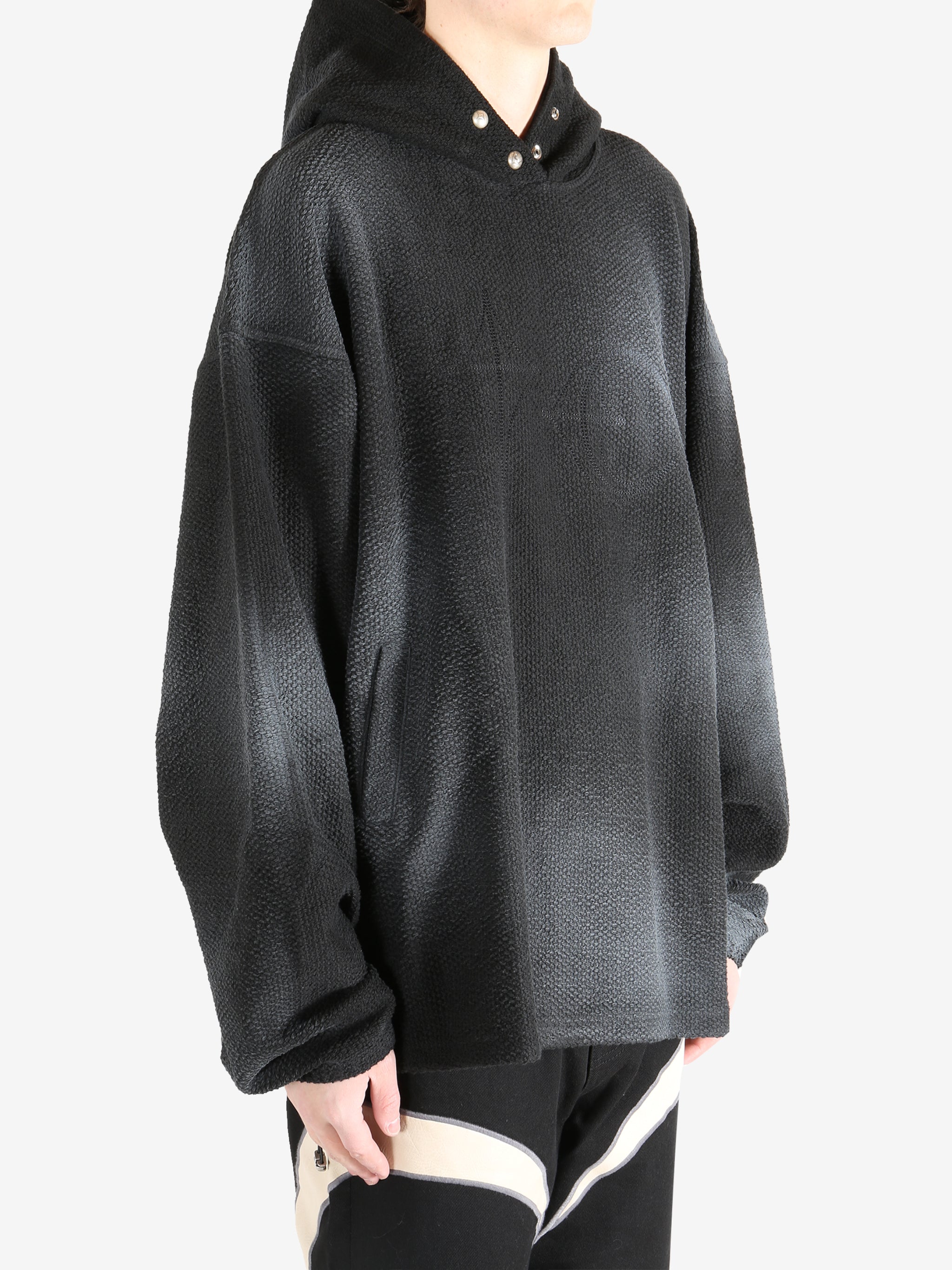 Black hoodie worn by a person, showing the hoodie's fit