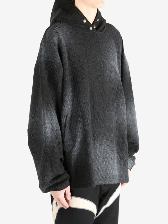 Black hoodie worn by a person, showing the hoodie's fit