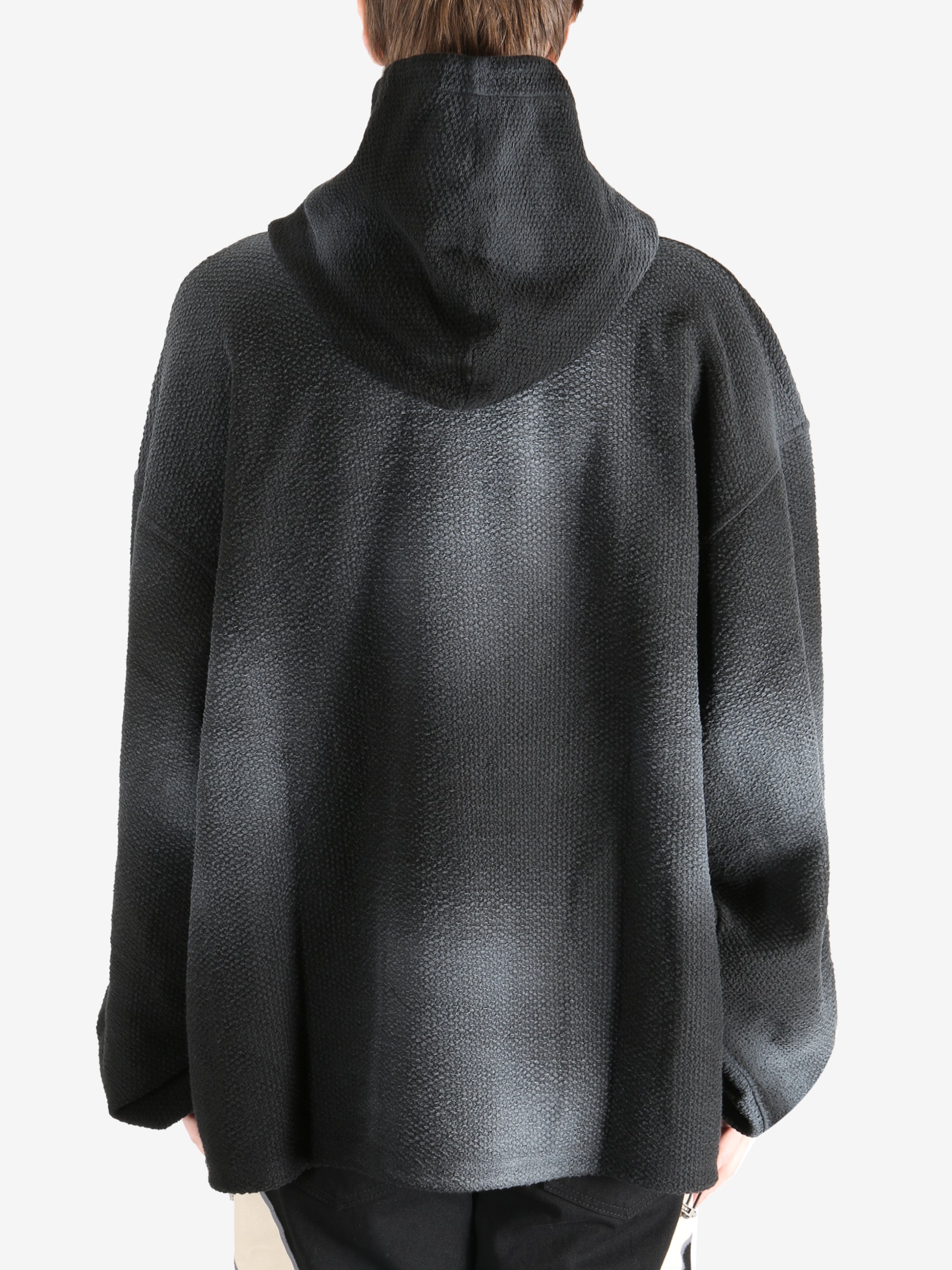 Black hoodie worn by a person, showing the hoodie's fit