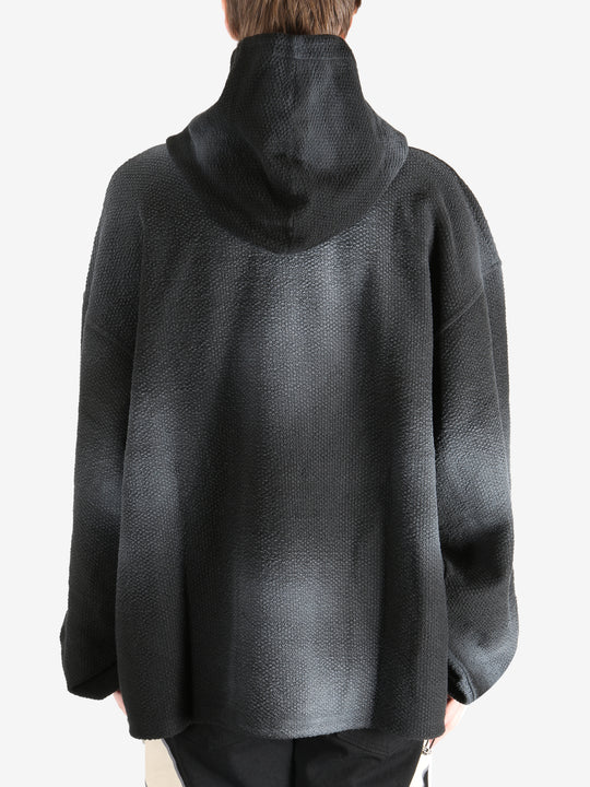 Black hoodie worn by a person, showing the hoodie's fit