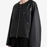 Black jacket worn by a person, side view