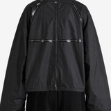 Black jacket worn by a person, back view