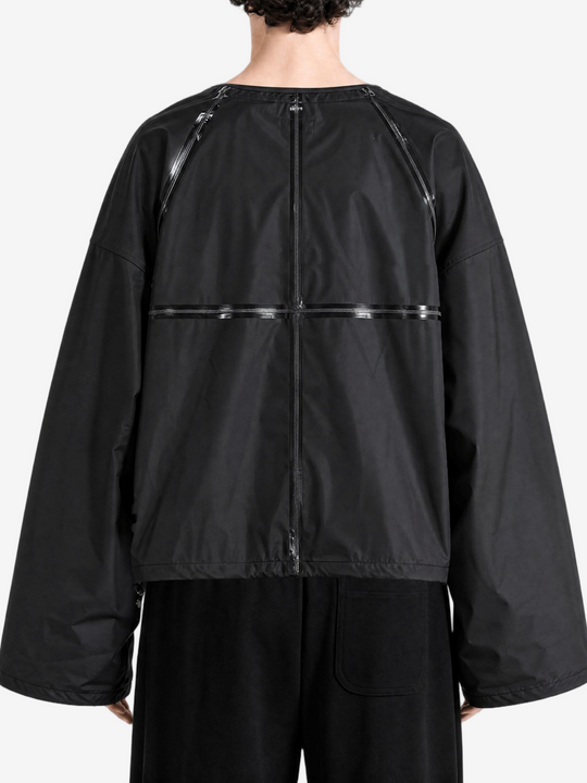 Black jacket worn by a person, back view