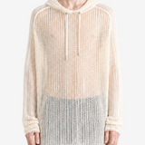 White knitwear worn by a person, showing the knitwear fit