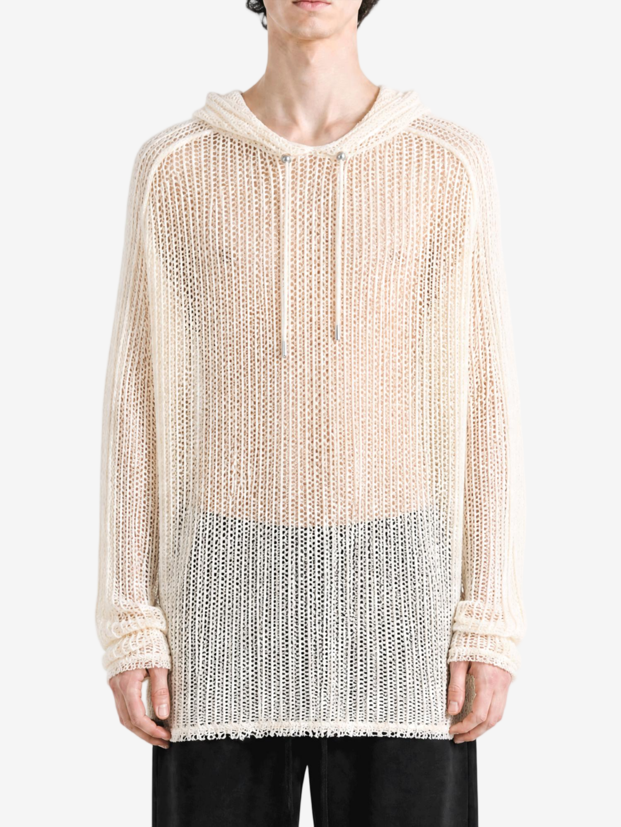 White knitwear worn by a person, showing the knitwear fit
