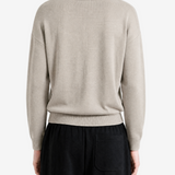 Grey knitwear worn by a person, back view