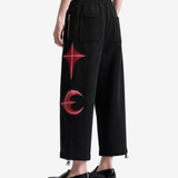 Black pants worn by a person, side view