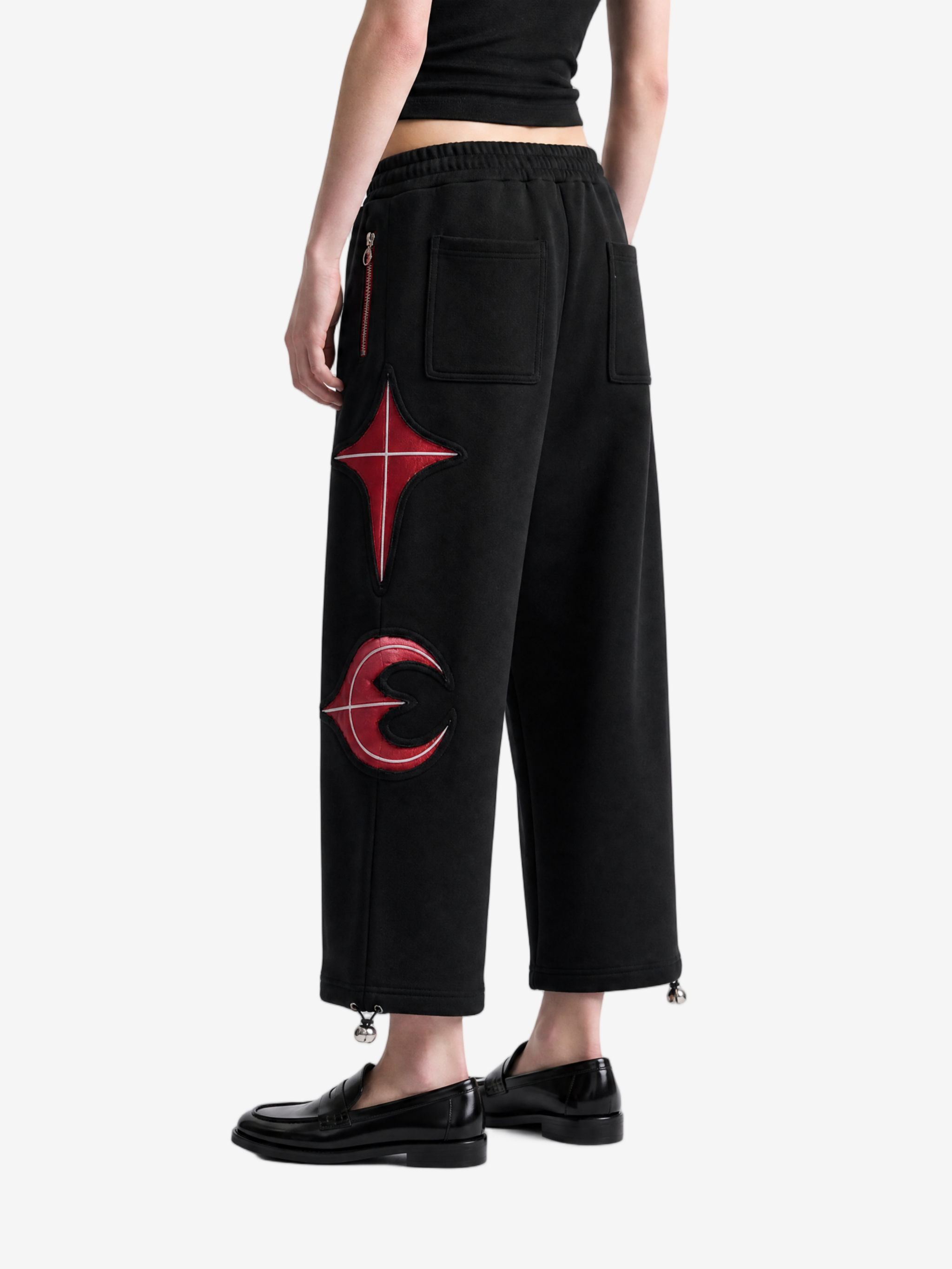 Black pants worn by a person, side view