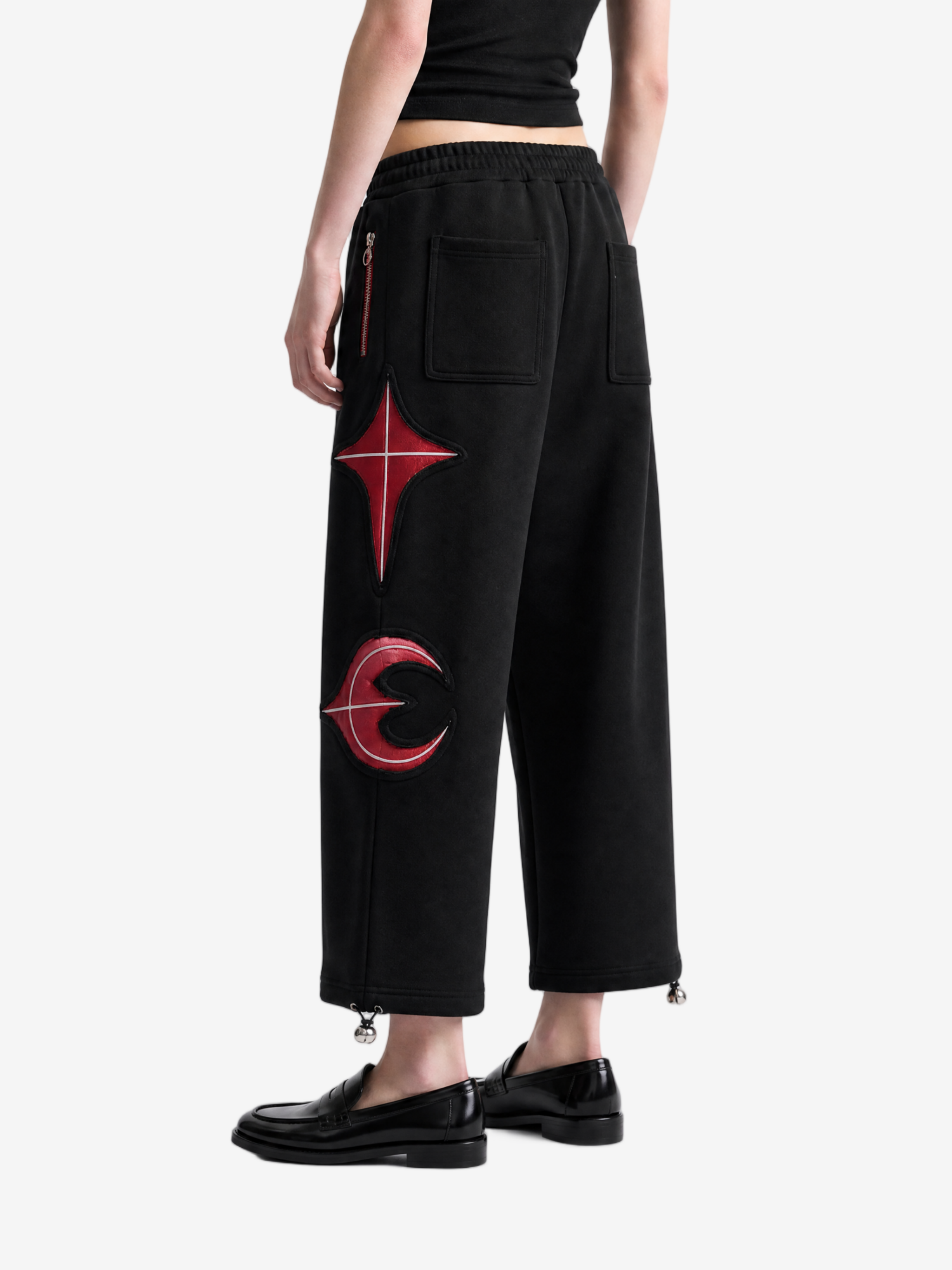Black pants worn by a person, side view