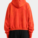 Red hoodie worn by a person, back view