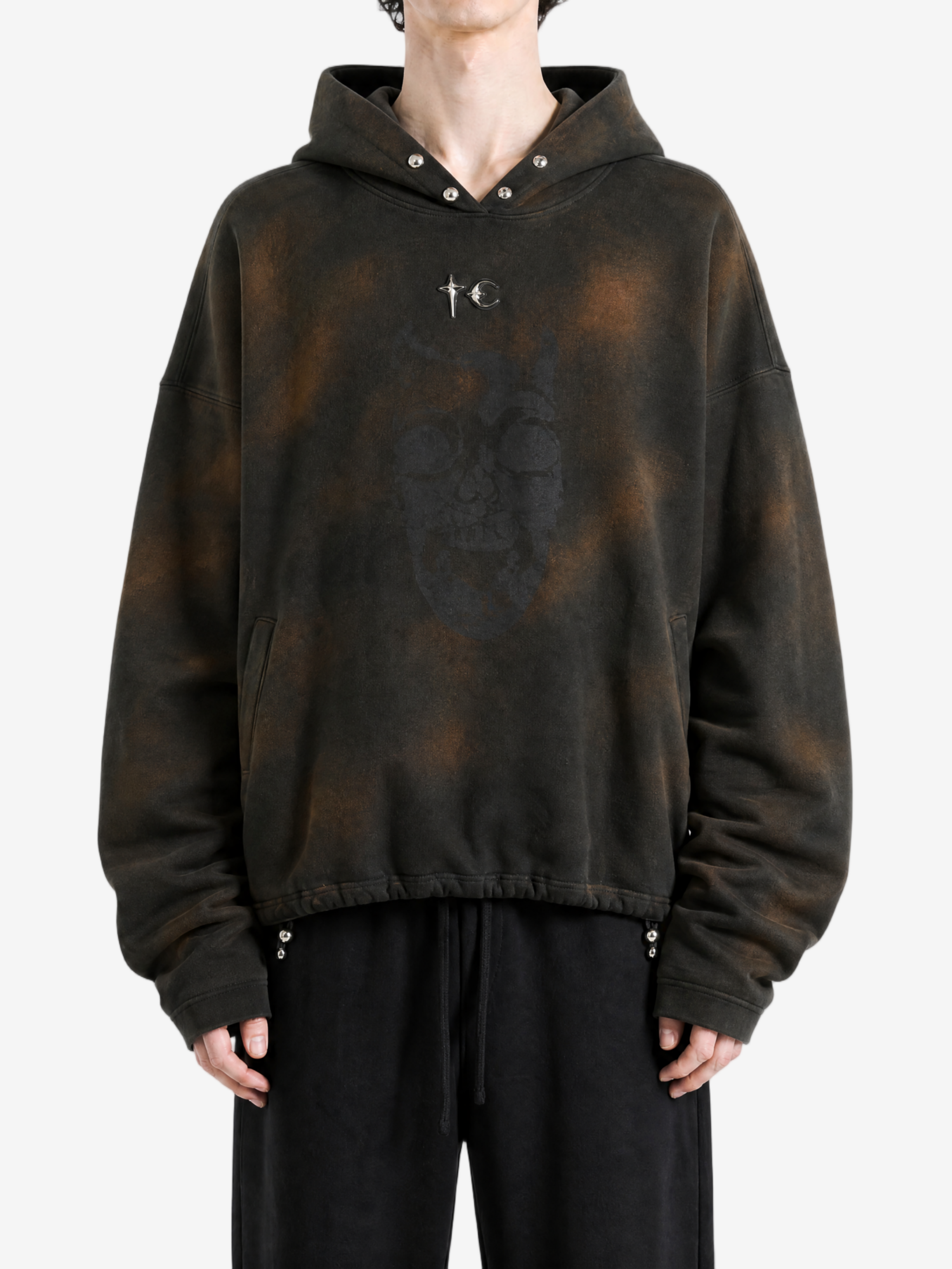Brown hoodie worn by a person, showing the hoodie fit