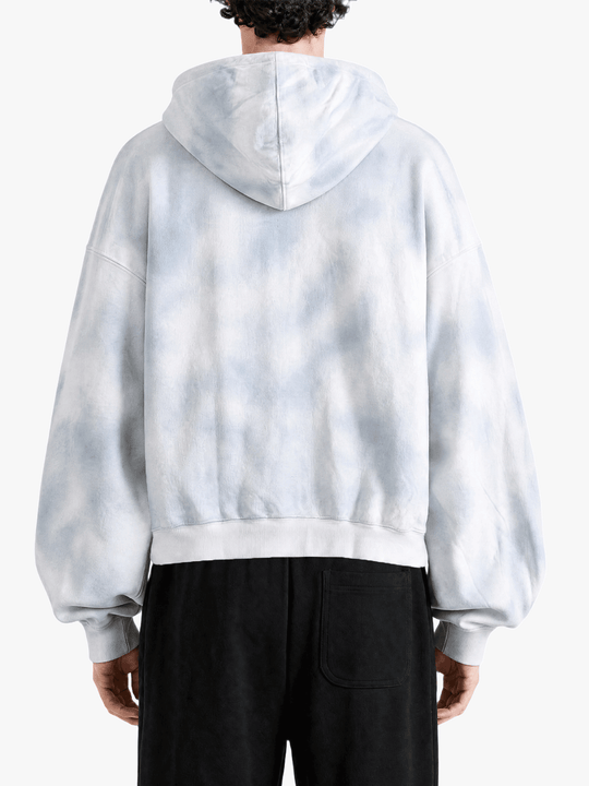 White hoodie worn by a person, back view