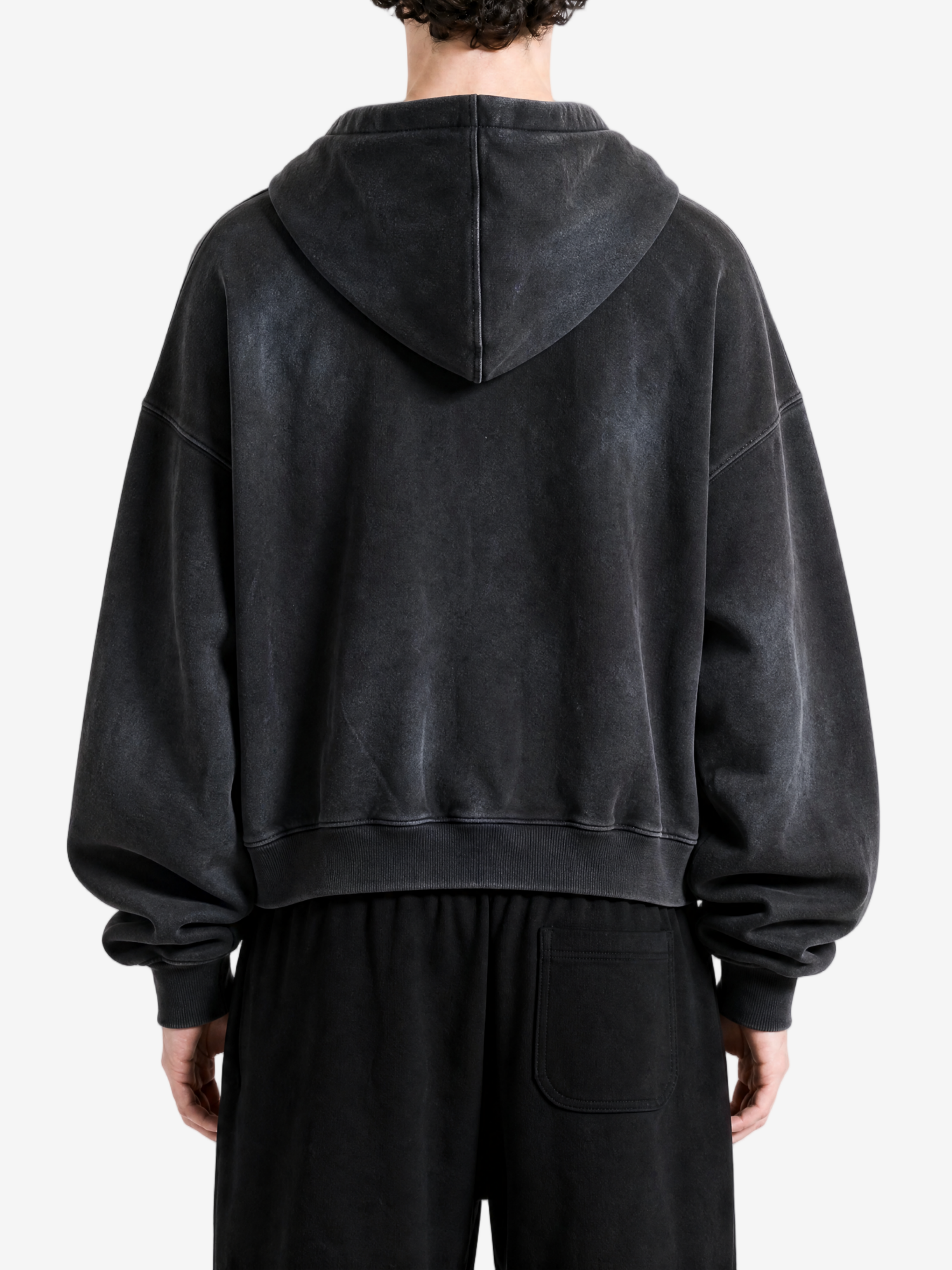 Black hoodie worn by a person, back view