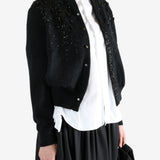 black Cardigan worn by a person, showing the Cardigan fit