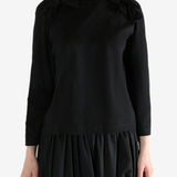 Black t-shirt worn by a person, showing the t-shirt fit