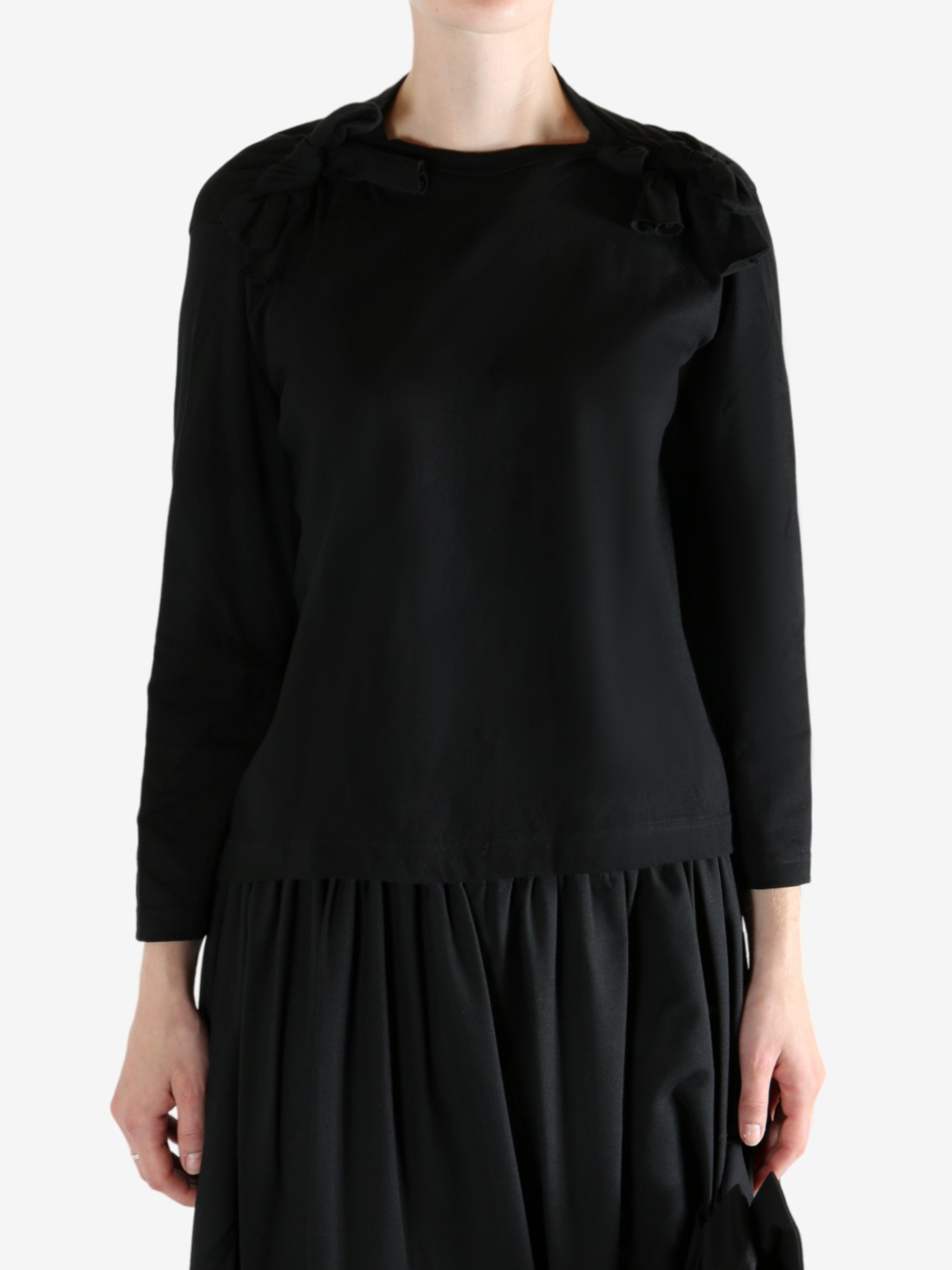 Black t-shirt worn by a person, showing the t-shirt fit