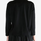 Black t-shirt worn by a person, showing the t-shirt fit