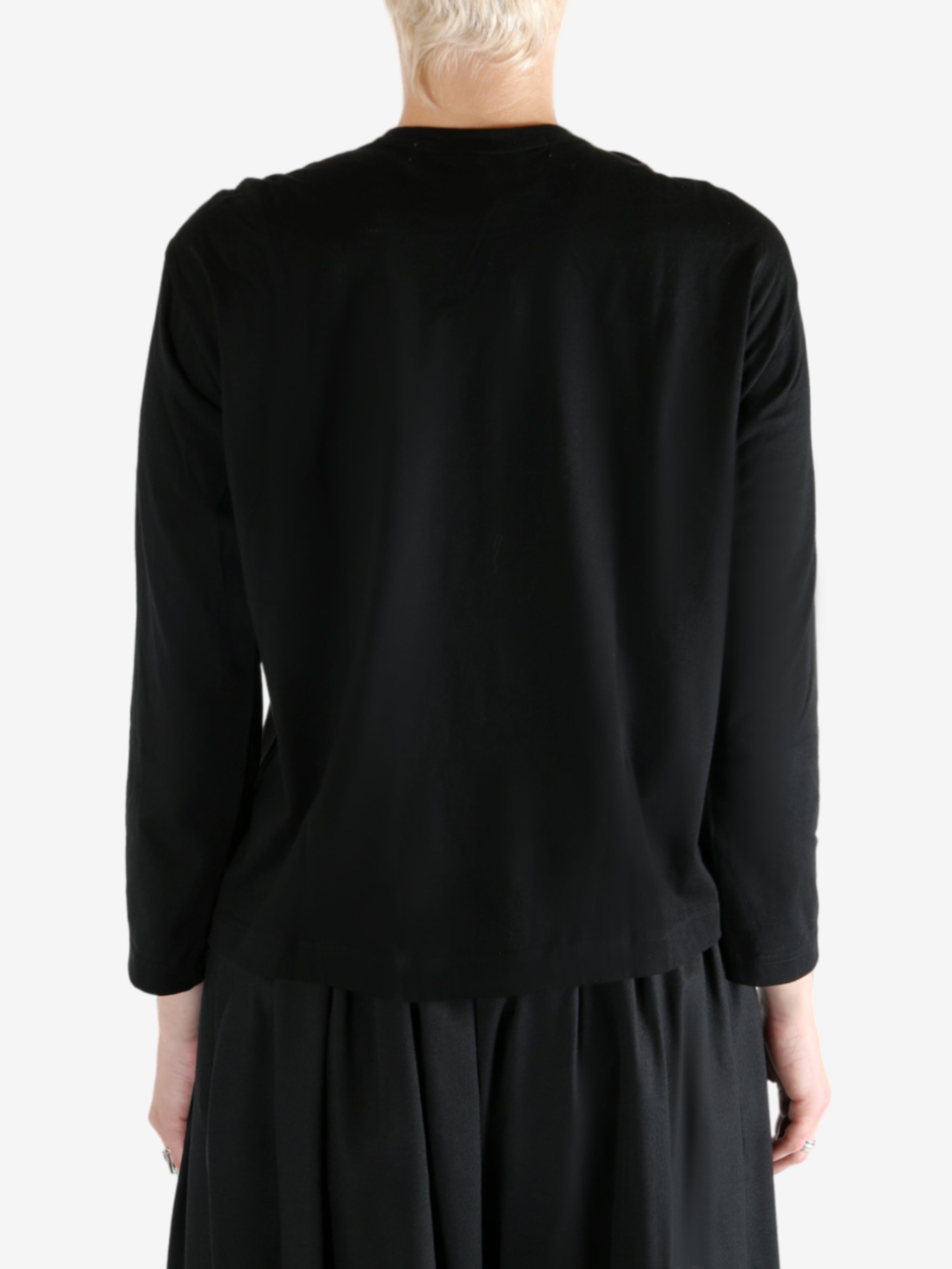 Black t-shirt worn by a person, showing the t-shirt fit