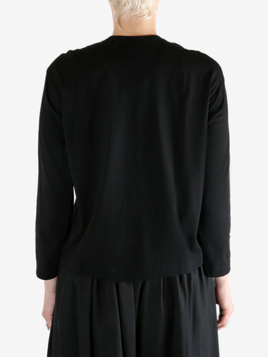 Black t-shirt worn by a person, showing the t-shirt fit