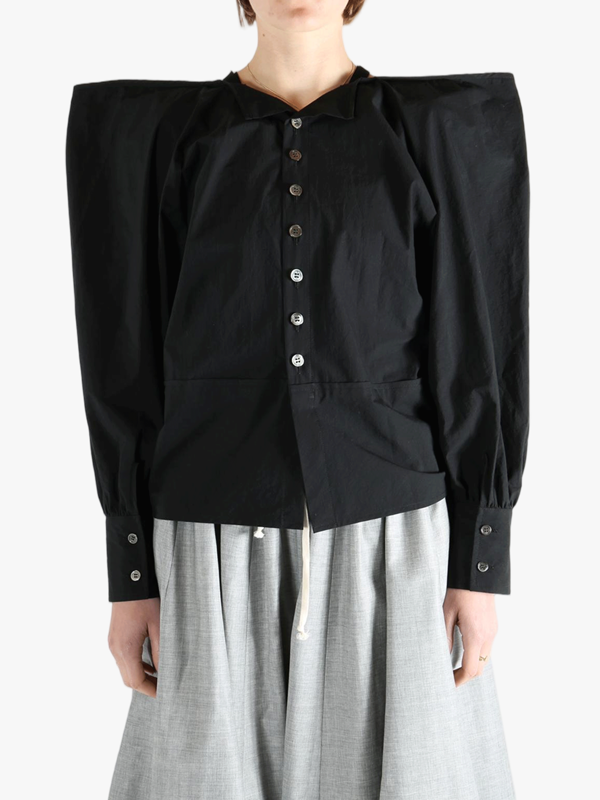 Black top  worn by a person, showing the top 's fit