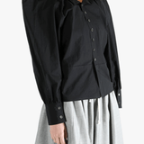 Black top  worn by a person, showing the top 's fit