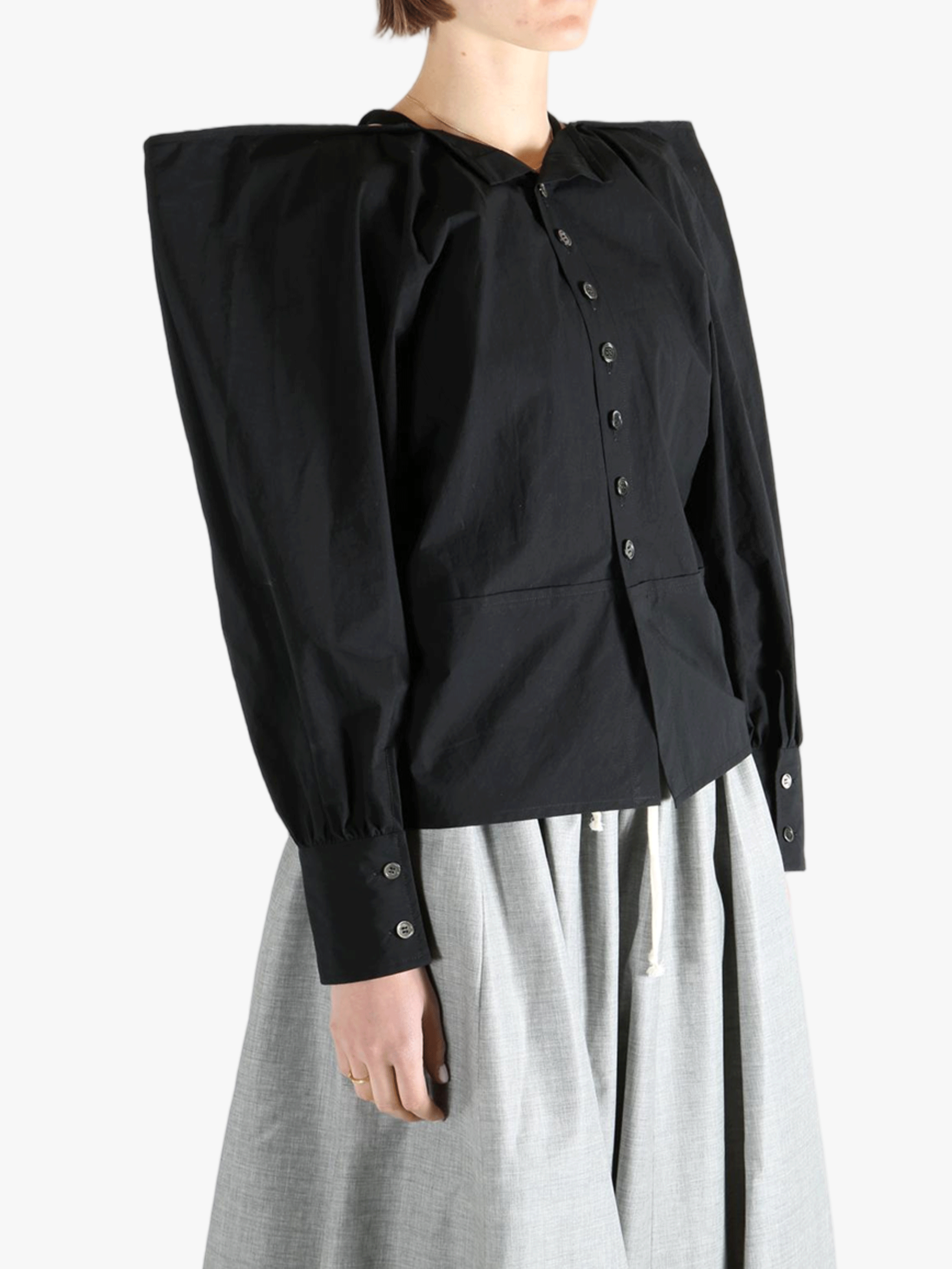 Black top  worn by a person, showing the top 's fit