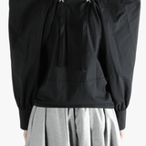 Black top  worn by a person, showing the top 's fit