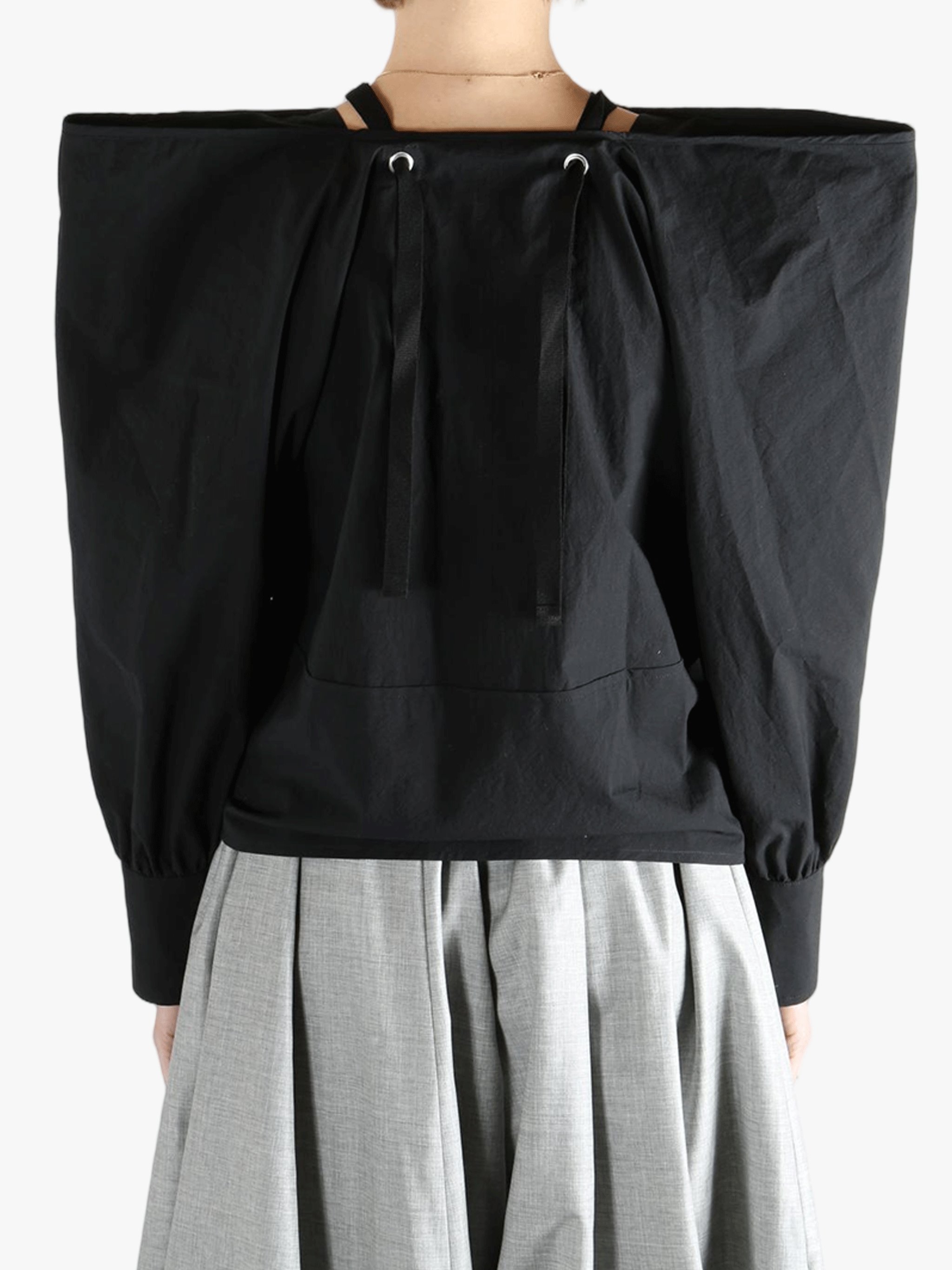 Black top  worn by a person, showing the top 's fit