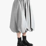 grey Skirt  worn by a person, showing the Skirt 's fit