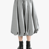 grey Skirt  worn by a person, showing the Skirt 's fit