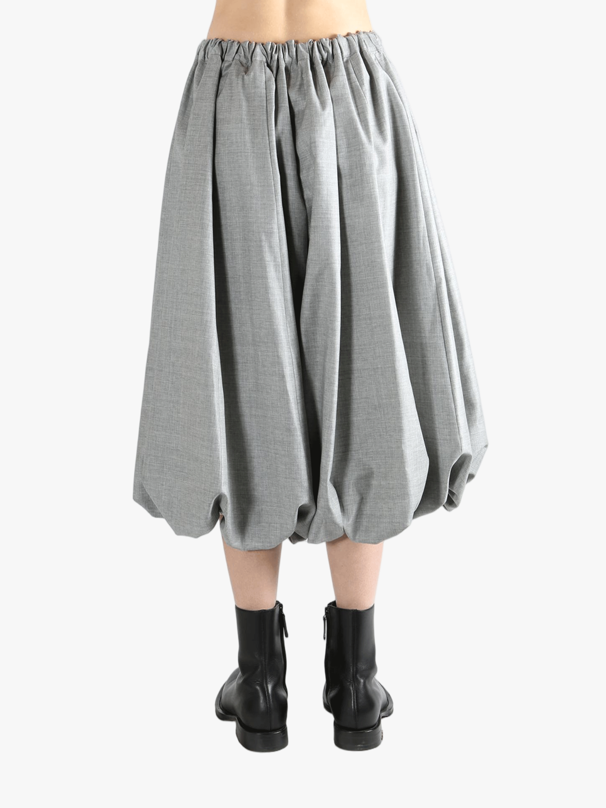 grey Skirt  worn by a person, showing the Skirt 's fit