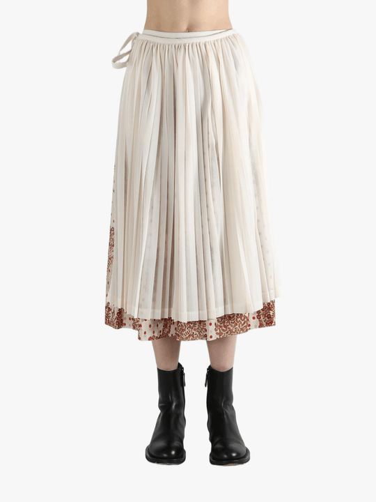 tan Skirt  worn by a person, showing the Skirt 's fit