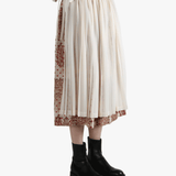 tan Skirt  worn by a person, showing the Skirt 's fit