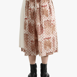 tan Skirt  worn by a person, showing the Skirt 's fit