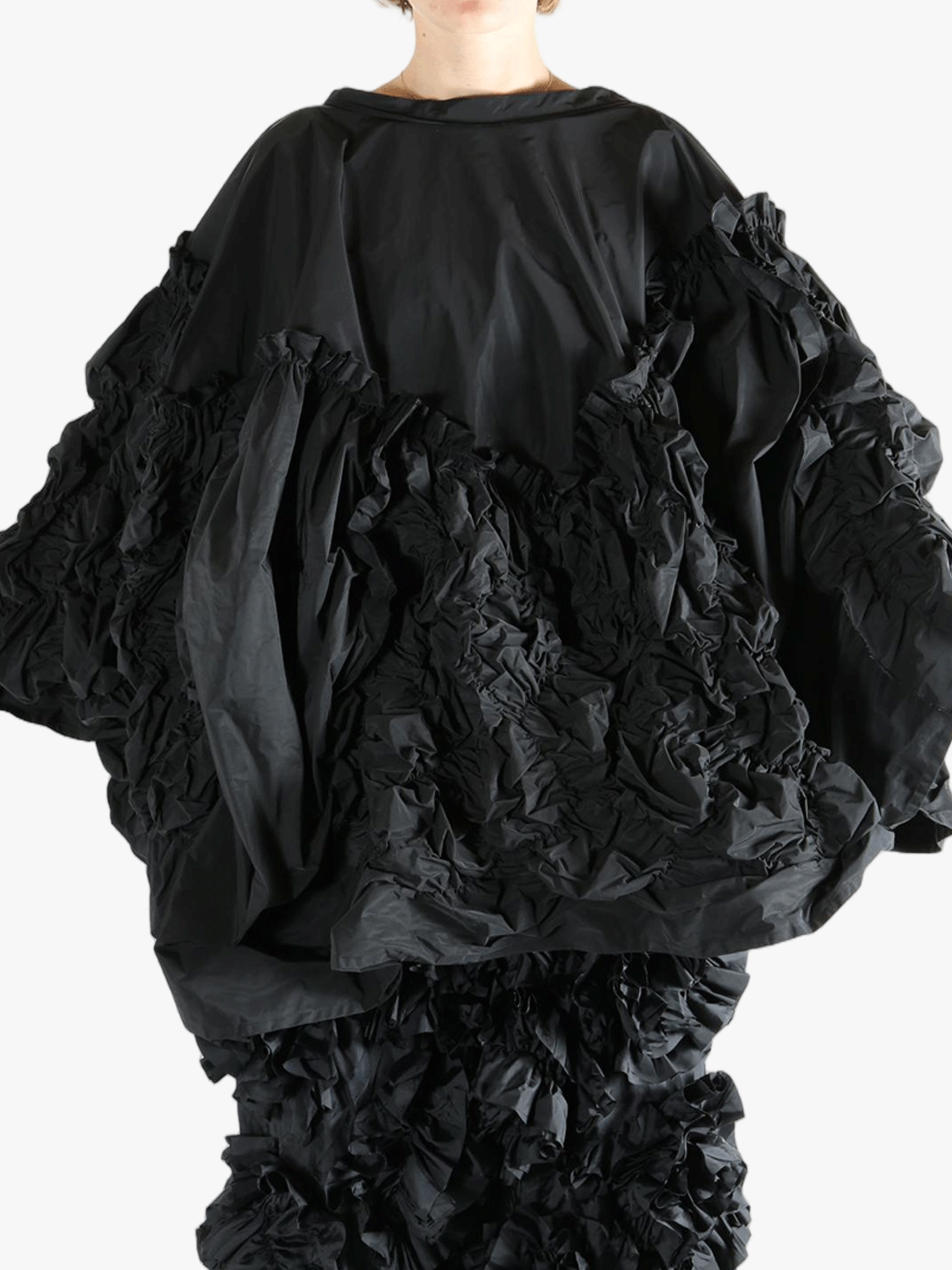 Black top  worn by a person, showing the top 's fit