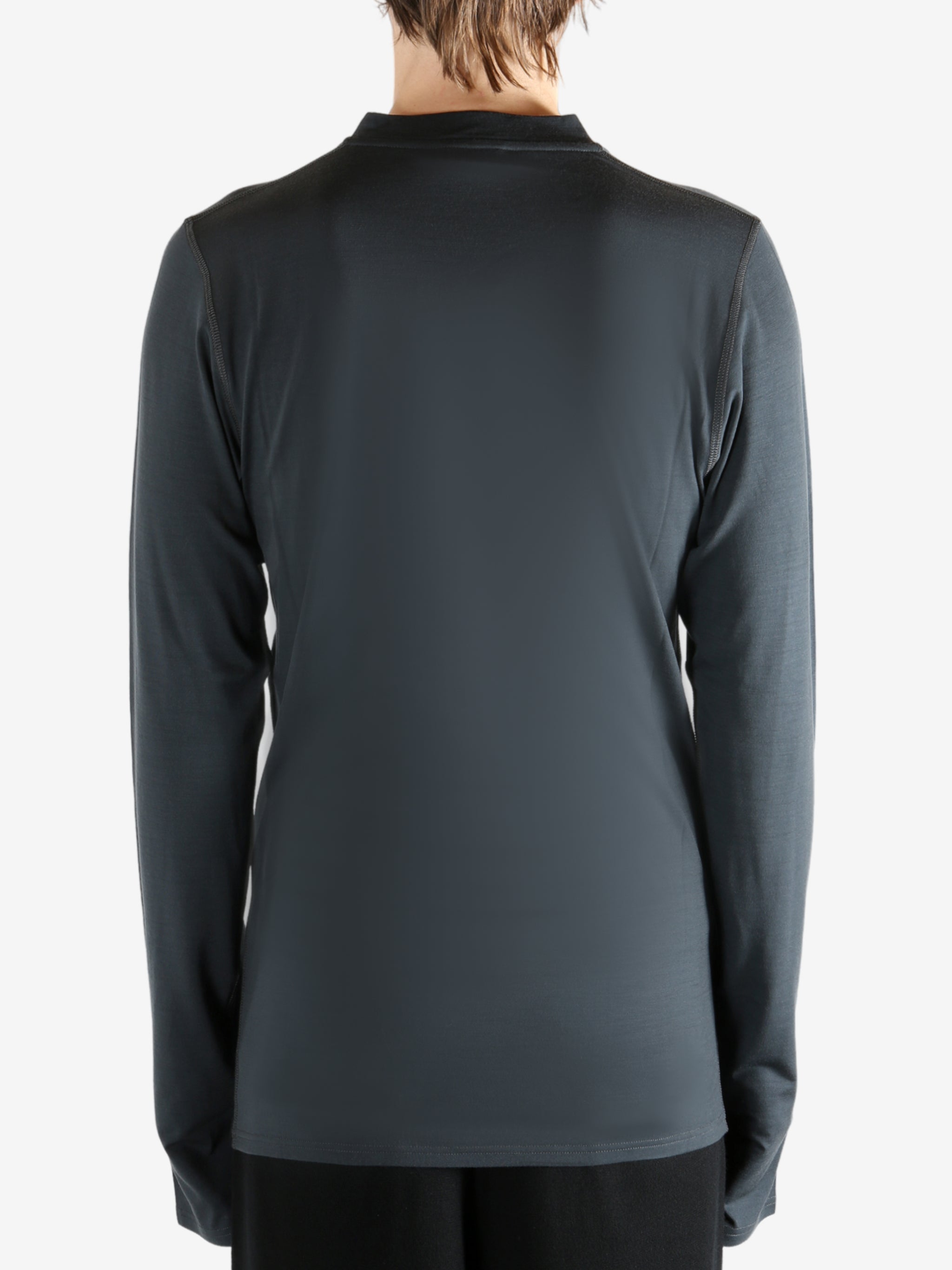 Black jersey worn by a person, showing the jersey's fit