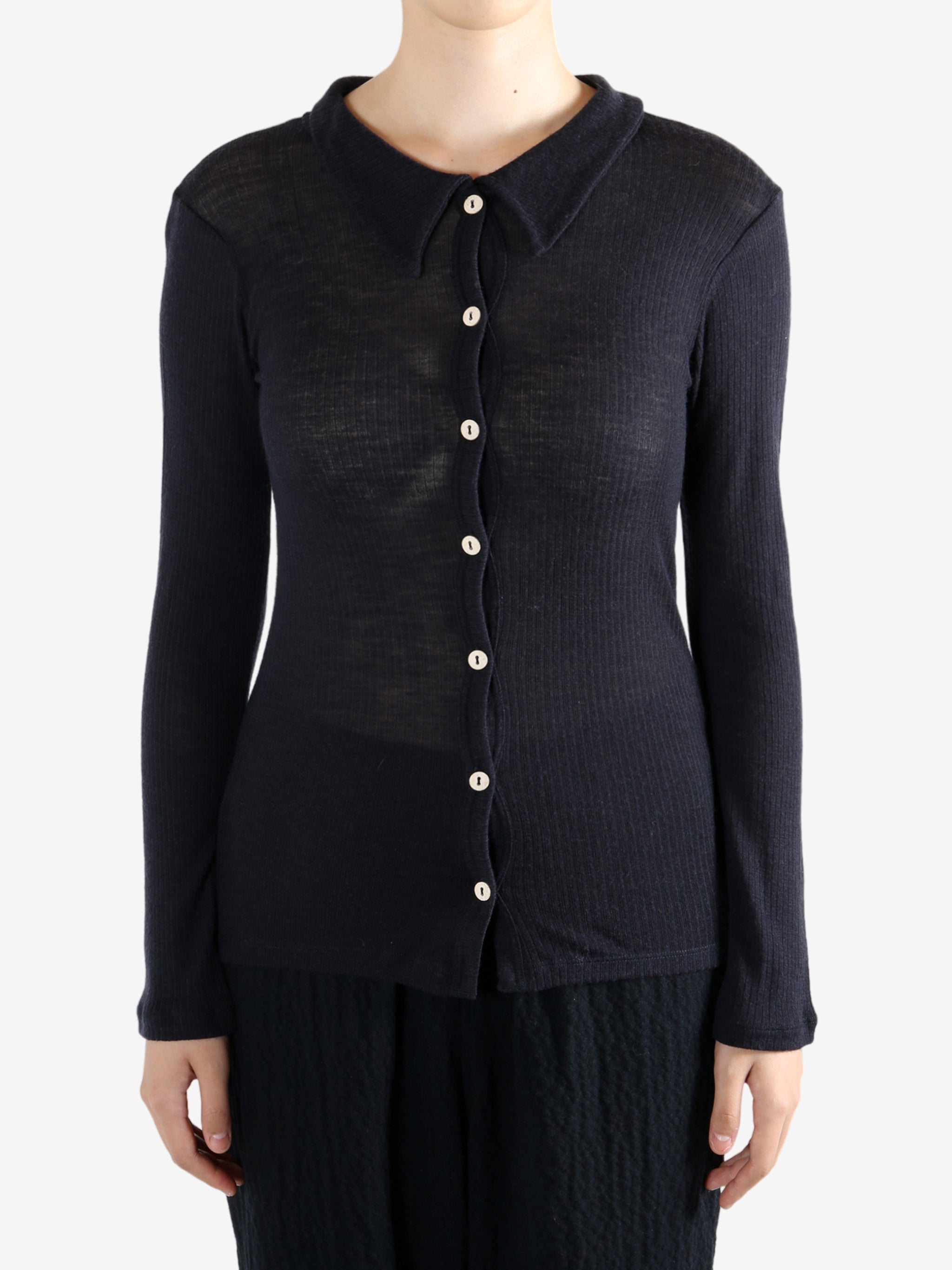 Navy shirt worn by a person, showing the shirt's fit