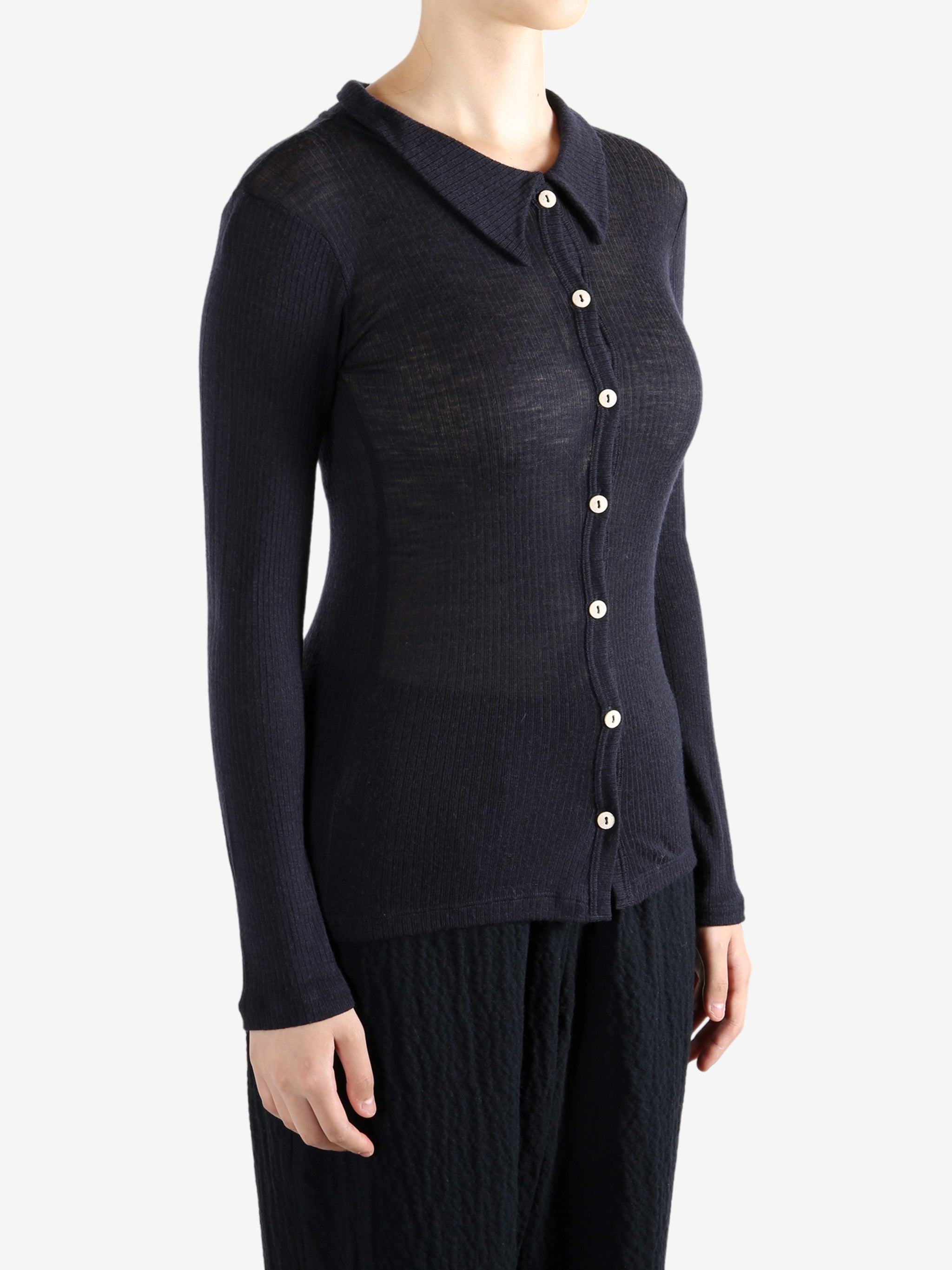 Navy shirt worn by a person, showing the shirt's fit