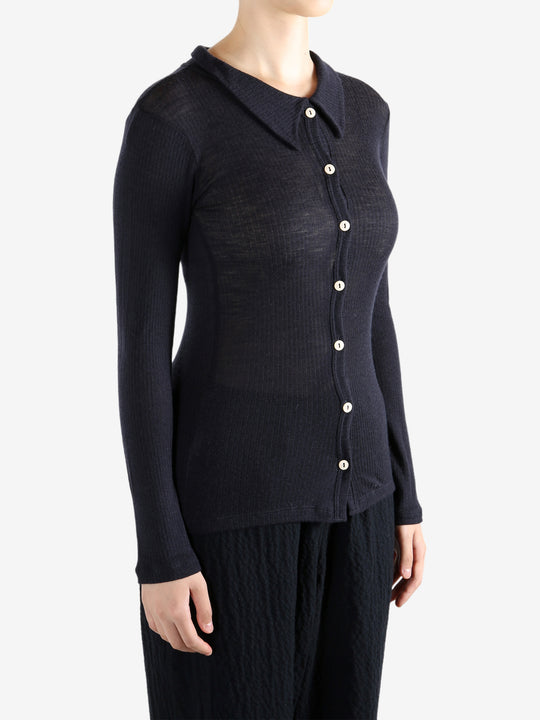 Navy shirt worn by a person, showing the shirt's fit