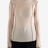 Tan shirt worn by a person, showing the shirt's fit